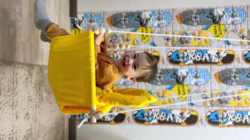 Adorable Baby Having Fun on Swing Indoors