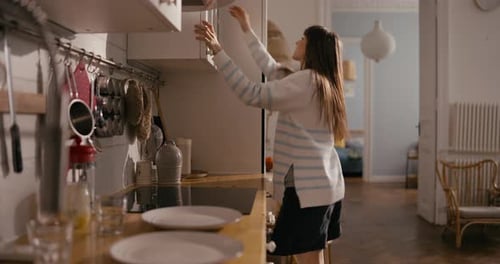 Cheerful Girl in Casual Dancing and Cooking Breakfast in the Morning in a Modern Cozy Apartment in