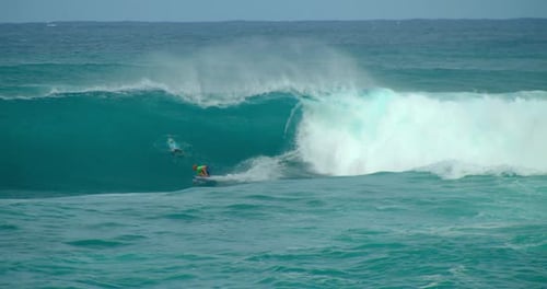 Surfer Riding Large Wave In Beautiful Blue Ocean, Slow Motion