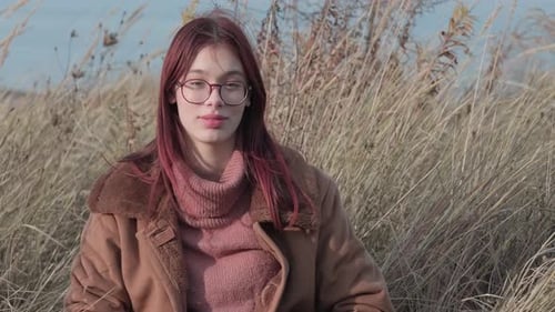 Stylish Young Woman in a Field of Wheat