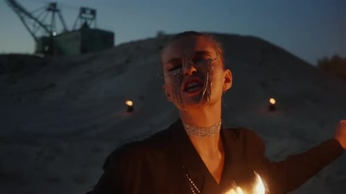 Fashionable Woman Dancing with Fire at Night