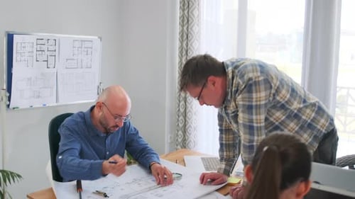 Architect and Foreman Analyzing Blueprints with Magnifier and Ruler for Construction Planning