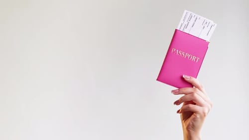 Hand Holding Passport and Boarding Pass