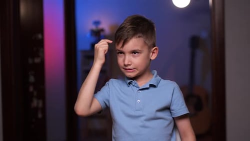 Young Boy Thinking With Finger on Forehead
