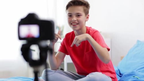 Teenager Recording Video with Camera on Bed