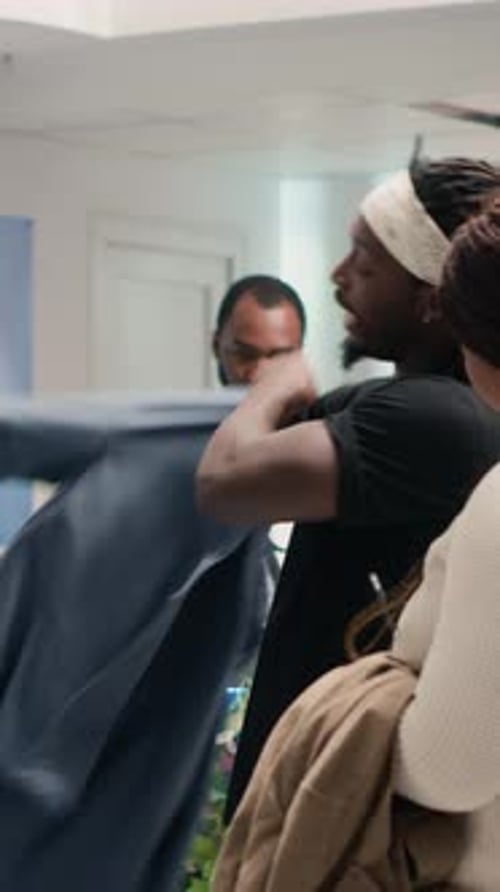 Vertical Video Man in Fashion Boutique Tries on Clothes