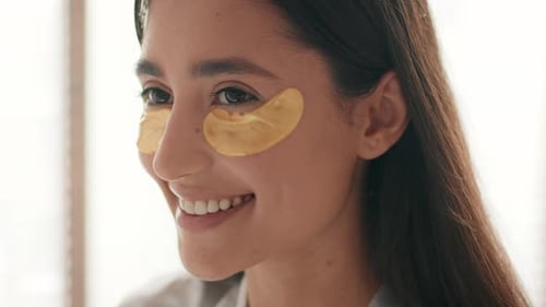 Smiling Woman with Gold Eye Masks, Beauty Treatment