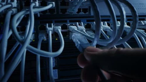 Hand Plugging Ethernet Cable into Data Server