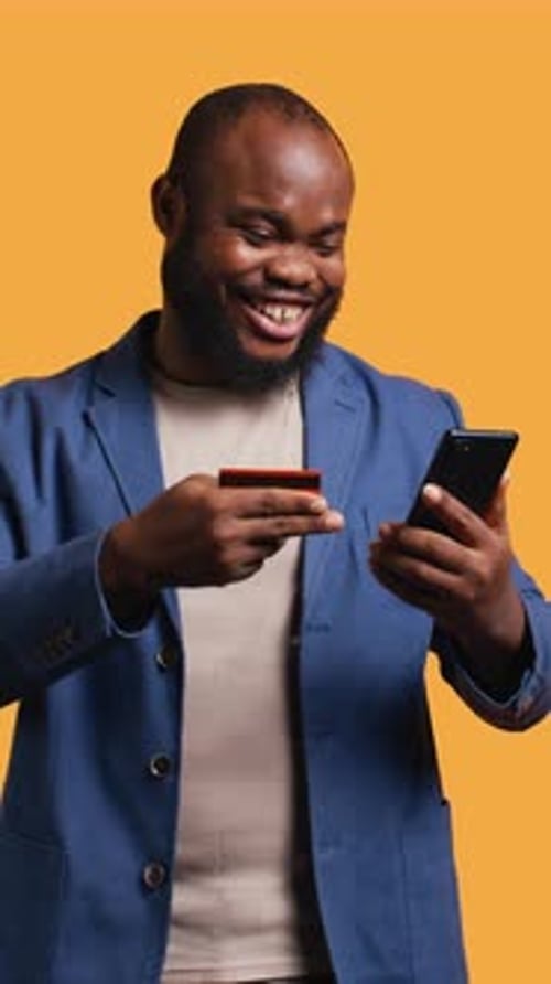 Vertical Video Happy Man Adding Payment Method on Phone Website Studio Background
