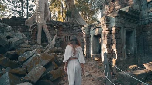Beautiful Woman Walks Through Ancient Temple Ruins, Cambodia