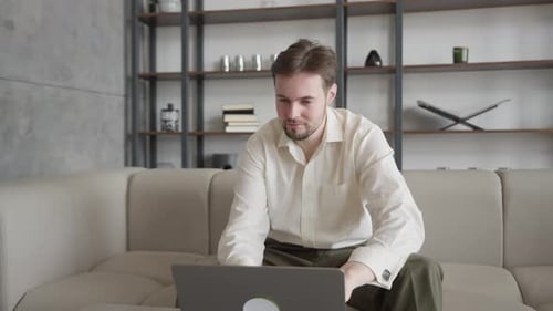 Caucasian Man Reacting To Good News While Watching Laptop Screen In Office