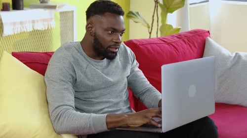 Man Working on Laptop Celebrates Good News