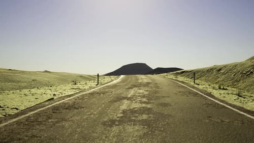 Bright Sunlight Bathes Deserted Trail Leading Toward Gentle Hills and Open Skies