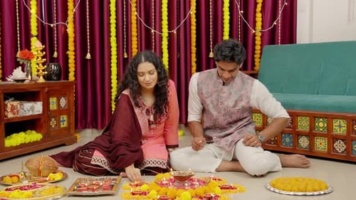 Young Couple Lights Candles During Diwali Celebration