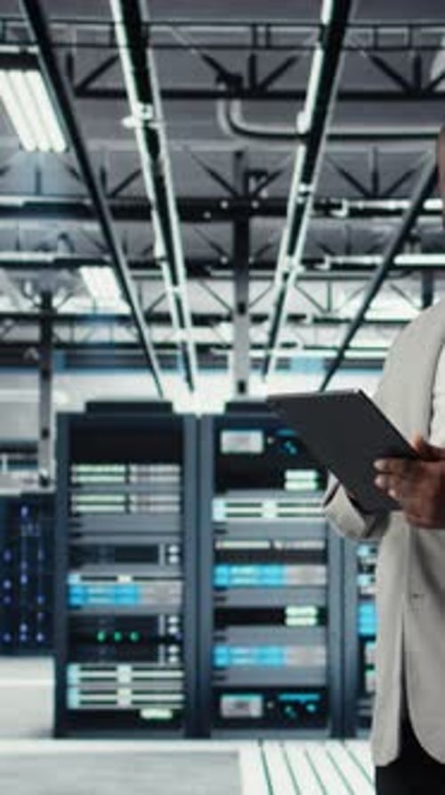 Man Using Tablet in Data Center Server Room