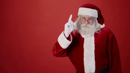 Frowning Santa Claus Wagging Finger, on Plain Red Background