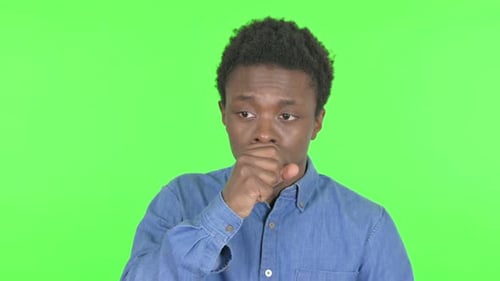 Coughing Sick Young African Man on Green Background