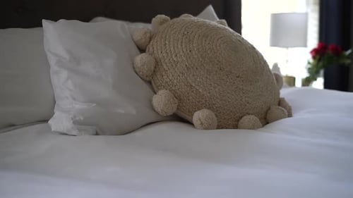 Freshly made comfortable bed in a stylish and relaxing room - panning view no people