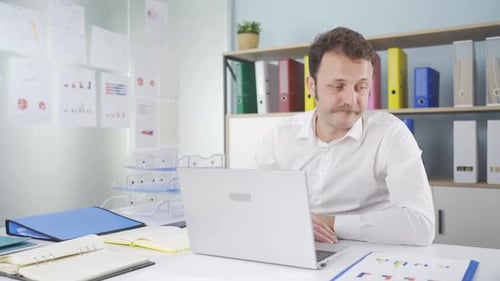 Man Working on Laptop in Office Workplace