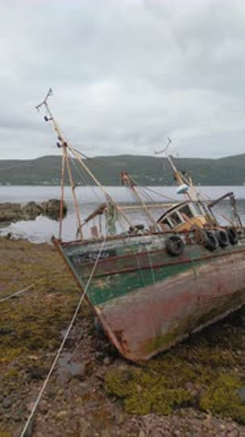 Aerial Drone of Abandoned Fishing Boat on Rocky Shore Scotland