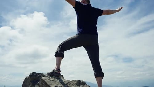 Man Looking at the Horizon Using Binoculars in the Mountain