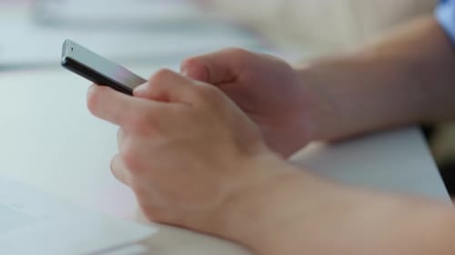 Unknown Business Man Hands Surfing Internet on Mobile Phone Indoors. Macro Businessman