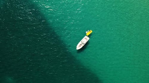 Boat with People Floating in the Ocean