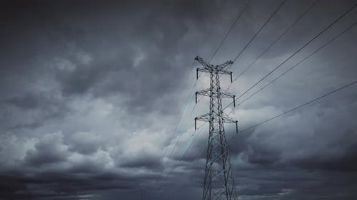 High Voltage Power Line Tower Under Cloudy Sky