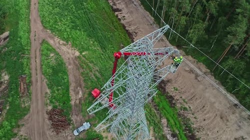 Workers Repairing High-Voltage Power Lines in the Countryside