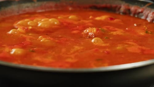 Simmering Red Tomato Sauce in Black Pan
