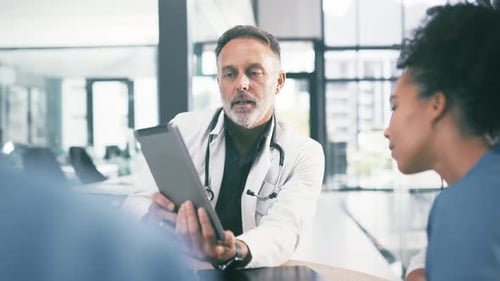Man, doctor and tablet in discussion with nurses, interns or medical employees at hospital