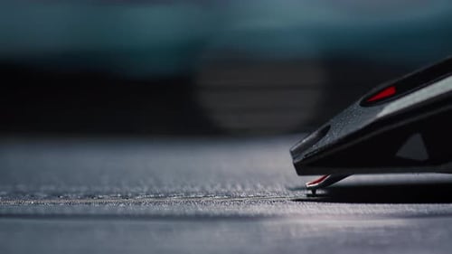 Extreme close-up of a record player's needle touching down on a spinning vinyl record album.