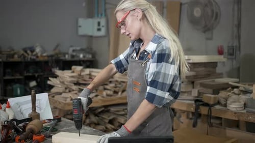 Carpenter is working at workshop.
