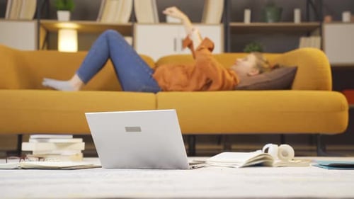 Young Adult Lounging with Phone and Laptop