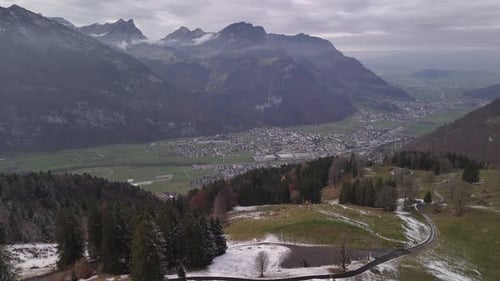 Glarus city Switzerland Fronalpstock mountains valley in winter Swiss Alps alpine drone view