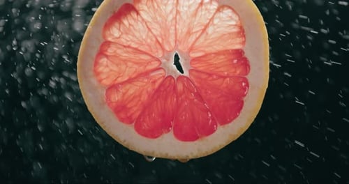 Grapefruit Slice with Dripping Water, Close Up