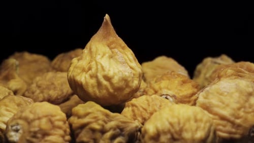 dried figs rotate, on a black background close-up. In move