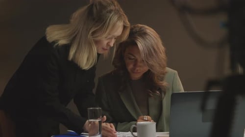 Two Women Collaborating on Project in Office
