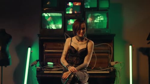 Seductive Young Adult Woman with Tattoos on Body Posing in Studio Portrait Zooming Shot From