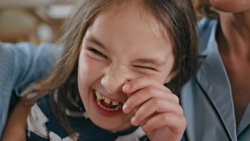 Cute Girl Making Silly Face with Mom