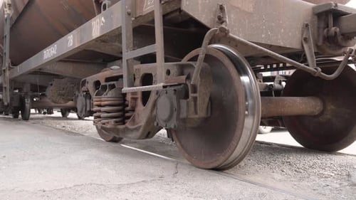 Close-up of axle and wheels at bottom of railway car,