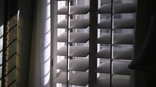 Sunlight Streaming Through Wooden Shutters