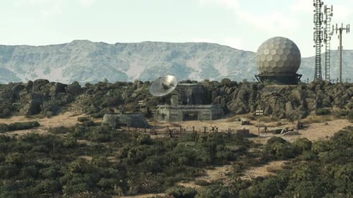 Distant View of Satellite Dishes and a Spherical Radar on Rocky Terrain