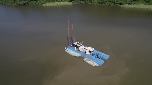 Transforming a swamp as a powerful dredge reshapes waterways for enhanced navigation and infrastruct