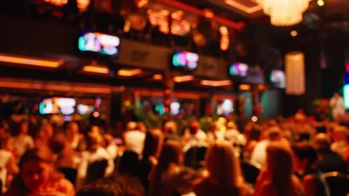 Blurred Crowd Attending Event in Urban Bar at Night