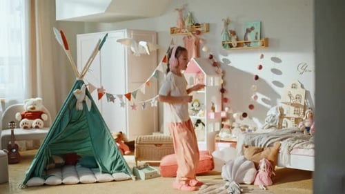 Young girl joyfully dancing in her brightly decorated bedroom