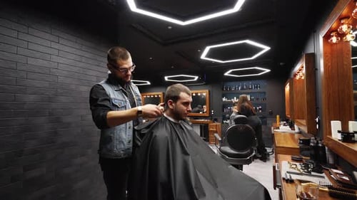 Barber Giving Haircut in a Barber Shop