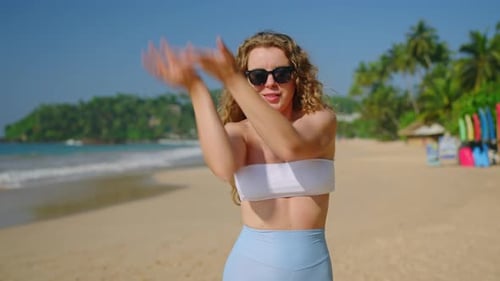 Sunglassclad Woman Dances at Sunny Beach Records Trendy Moves for Social Media Content Creator