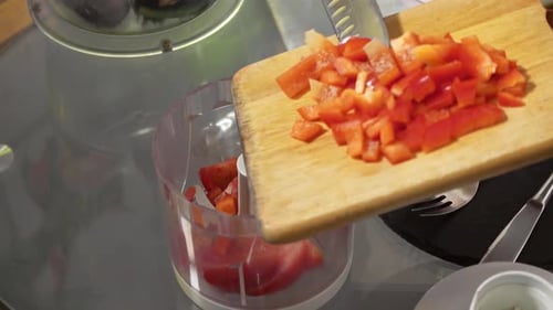 Woman Adds Diced Red Pepper to Food Processor