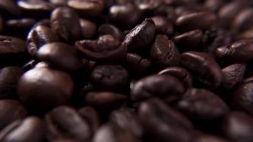 Close-up of coffee beans falling in slow motion